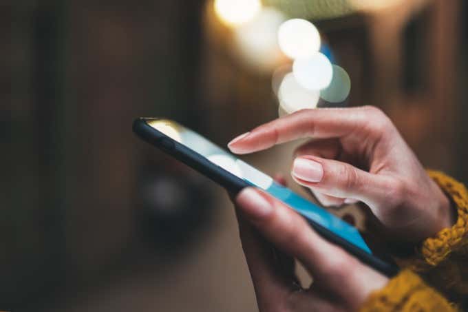 point finger on screen phone closeup, person texting text message, hipster touch blue screen on smartphone light night city, girls using in hands mobile phone close up, online wi-fi internet - Online Tech Tips What to Do When You Can’t Send Text Messages From Android image 2