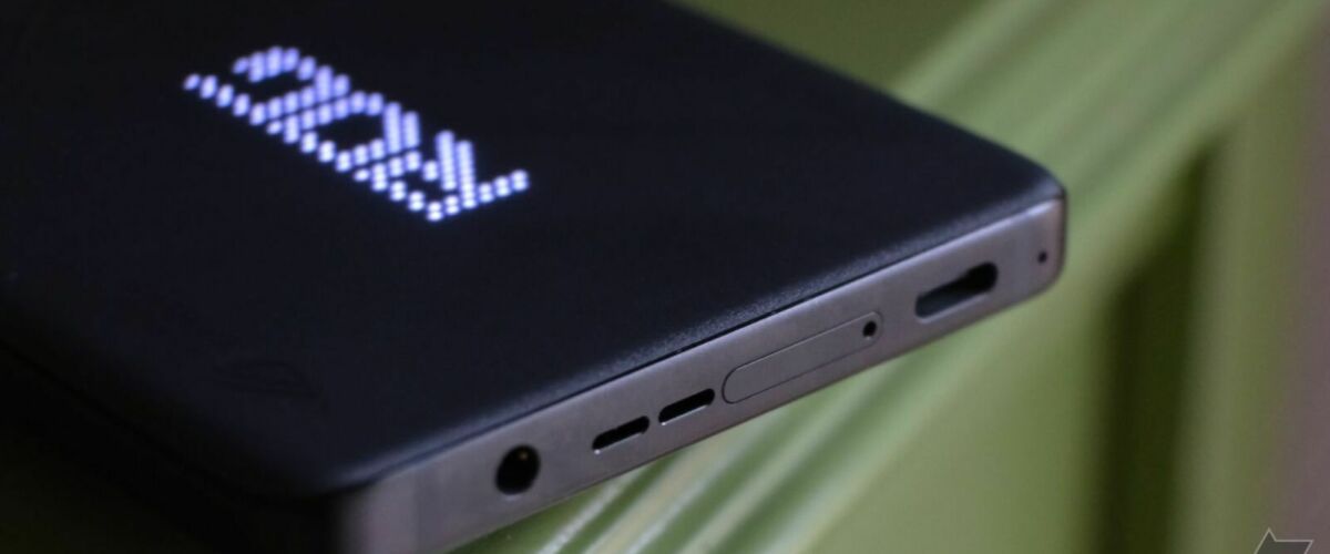 ROG Phone 8 Pro showing bottom ports while laying on green endtable